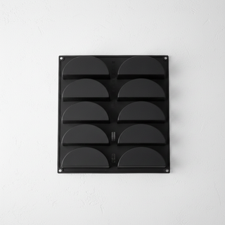 Black silicone mold 8 cavities on white concrete